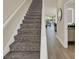 Carpeted stairway leading to the upper level, with a view of the main living area and adjacent bathroom at 17441 Hidden Forest Dr, Clermont, FL 34714