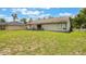 View of the home's backyard with grassy lawn and patio at 1785 6Th Ave, Deland, FL 32724