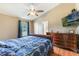 Spacious bedroom with wood floors, ceiling fan, and large dresser at 1785 6Th Ave, Deland, FL 32724