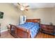 Comfortable bedroom with a large bed, ceiling fan, and dark wood furniture with plenty of light at 1785 6Th Ave, Deland, FL 32724
