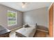 Bright bedroom featuring a white chaise lounge, neutral walls, and a window with natural light at 1785 6Th Ave, Deland, FL 32724