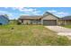 Charming single-Gathering home featuring stone accents, a well-manicured lawn, and an attached two-car garage at 1785 6Th Ave, Deland, FL 32724