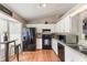 Bright kitchen featuring white cabinets, black appliances, and wood floors at 1785 6Th Ave, Deland, FL 32724
