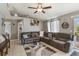 Cozy living room featuring a sectional sofa, ceiling fan, and sliding doors to the outdoors at 1785 6Th Ave, Deland, FL 32724