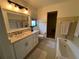 Well-lit bathroom featuring a vanity with drawers and a shower-tub combination at 1809 Pepperidge Dr, Orlando, FL 32806