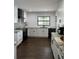 Stylish kitchen featuring white cabinets, dark hardware and stainless steel appliances at 1809 Pepperidge Dr, Orlando, FL 32806