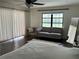 Cozy main bedroom with hardwood floors, large windows, and a comfortable seating area at 1809 Pepperidge Dr, Orlando, FL 32806