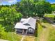 Overhead view of the residence highlighting its classic architecture, metal roof, and expansive lawn at 1826 W Silver Springs Blvd, Ocala, FL 34475