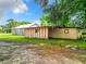 Backyard area with a shed and open lawn at 1826 W Silver Springs Blvd, Ocala, FL 34475