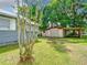 Backyard view showing lawn, trees, and the exterior of the home at 1826 W Silver Springs Blvd, Ocala, FL 34475