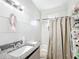 Bathroom featuring tiled walls, a granite countertop, and shower with curtain at 1826 W Silver Springs Blvd, Ocala, FL 34475