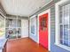 Inviting front porch with screened area, showing access to red front door and additional entry at 1826 W Silver Springs Blvd, Ocala, FL 34475
