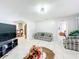 Spacious living room offers tile floors and seamless transition to the dining and bedroom areas at 1826 W Silver Springs Blvd, Ocala, FL 34475