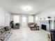Inviting living area featuring tiled floors, a decorative fireplace, and ample natural light at 1826 W Silver Springs Blvd, Ocala, FL 34475