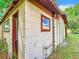 Corner view of a block construction shed with red trim around the door and windows at 1826 W Silver Springs Blvd, Ocala, FL 34475
