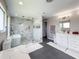 An updated bathroom featuring a glass shower, soaking tub, and dual sink vanity with lots of counter space at 224 Hammock Dunes Pl, Orlando, FL 32828