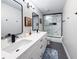 Bathroom featuring double sink vanity with modern fixtures and a walk-in shower with marble-style tile at 224 Hammock Dunes Pl, Orlando, FL 32828