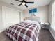 Cozy bedroom with plaid bedding, ceiling fan, and natural light from the large window at 224 Hammock Dunes Pl, Orlando, FL 32828