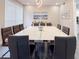 A modern dining room with a large white table, leather chairs, and stylish decor at 224 Hammock Dunes Pl, Orlando, FL 32828