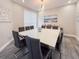 A modern dining room with a large white table, leather chairs, and stylish decor at 224 Hammock Dunes Pl, Orlando, FL 32828