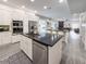 Modern kitchen with a stainless steel dishwasher, granite counter top, and an island with bar stool seating at 224 Hammock Dunes Pl, Orlando, FL 32828