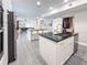 Modern kitchen with stainless steel appliances, a granite countertop, and an island with bar stool seating at 224 Hammock Dunes Pl, Orlando, FL 32828