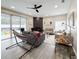 Bright living room boasting modern furniture, a dark tiled fireplace, ceiling fan, and access to the pool at 224 Hammock Dunes Pl, Orlando, FL 32828