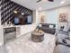 Cozy living room featuring an entertainment center, wine fridge, couches, and statement wall paper at 224 Hammock Dunes Pl, Orlando, FL 32828