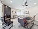 A cozy living room featuring a fireplace, neutral-toned sofas, a ceiling fan and lots of light at 224 Hammock Dunes Pl, Orlando, FL 32828