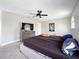 Large bedroom featuring a ceiling fan, two windows, a chest of drawers, and a cozy bed at 224 Hammock Dunes Pl, Orlando, FL 32828