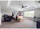 Bright primary bedroom featuring a ceiling fan, decorative art, a desk, sitting area, and natural light at 224 Hammock Dunes Pl, Orlando, FL 32828