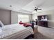 Spacious primary bedroom with tray ceilings, a ceiling fan, large window, and a television at 224 Hammock Dunes Pl, Orlando, FL 32828