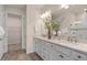 Bathroom features a double vanity, granite countertops, neutral paint, bronze fixtures, and a glass-door shower at 2334 Daisy Tree Rd, St Cloud, FL 34771