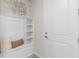 Inviting entryway featuring a built-in bench with storage, white wainscoting, and stylish decor at 2334 Daisy Tree Rd, St Cloud, FL 34771