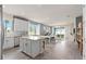 Open kitchen with a center island seamlessly connects to the living and dining areas at 2334 Daisy Tree Rd, St Cloud, FL 34771
