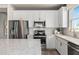 Bright kitchen with stainless steel appliances, marble counters, and white cabinetry at 2334 Daisy Tree Rd, St Cloud, FL 34771