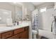Bathroom with a vanity, mirror, toilet, and shower-tub combo with a blue and white shower curtain at 2417 Liner Ave, Apopka, FL 32703