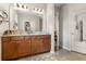 Primary bathroom with a double sink vanity, an expansive mirror, and modern fixtures and finishes at 2417 Liner Ave, Apopka, FL 32703