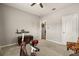 Spare bedroom includes neutral colored walls, a ceiling fan, a sitting chair, and carpet at 2417 Liner Ave, Apopka, FL 32703