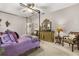 The main bedroom features a four-poster bed, a ceiling fan, a dresser, and two sitting chairs at 2417 Liner Ave, Apopka, FL 32703