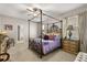 Main bedroom features a four-poster bed, a ceiling fan, and an ensuite bathroom with a walk-in closet at 2417 Liner Ave, Apopka, FL 32703