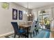 Stylish dining room with an elegant table, seating for six, and sliding glass doors to the backyard, perfect for gatherings at 2417 Liner Ave, Apopka, FL 32703