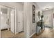 Inviting hallway with wood floors, leading to the bathroom and featuring stylish decorations at 2417 Liner Ave, Apopka, FL 32703