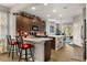 Modern kitchen with a breakfast bar, pendant lighting, and stainless steel appliances, perfect for cooking enthusiasts at 2417 Liner Ave, Apopka, FL 32703