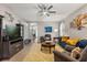 Spacious living area with a ceiling fan, plush seating, and a view into the entry, ideal for entertaining at 2417 Liner Ave, Apopka, FL 32703