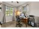 Cozy home office featuring wood floors, natural light, a wooden desk, and neutral gray walls at 2417 Liner Ave, Apopka, FL 32703