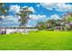 Expansive backyard with lush green lawn and views of the lake, along with a sitting area at 2500 Lee Rd # 243, Winter Park, FL 32789
