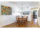 Bright dining room features wood floors, table with four chairs, and modern lighting at 2500 Lee Rd # 243, Winter Park, FL 32789