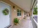 A condo front door with a wreath is accented by potted plants and the walkway to the entrance at 2500 Lee Rd # 243, Winter Park, FL 32789