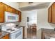 Cozy kitchen provides eat-in space, white appliances, and wood cabinets at 2500 Lee Rd # 243, Winter Park, FL 32789